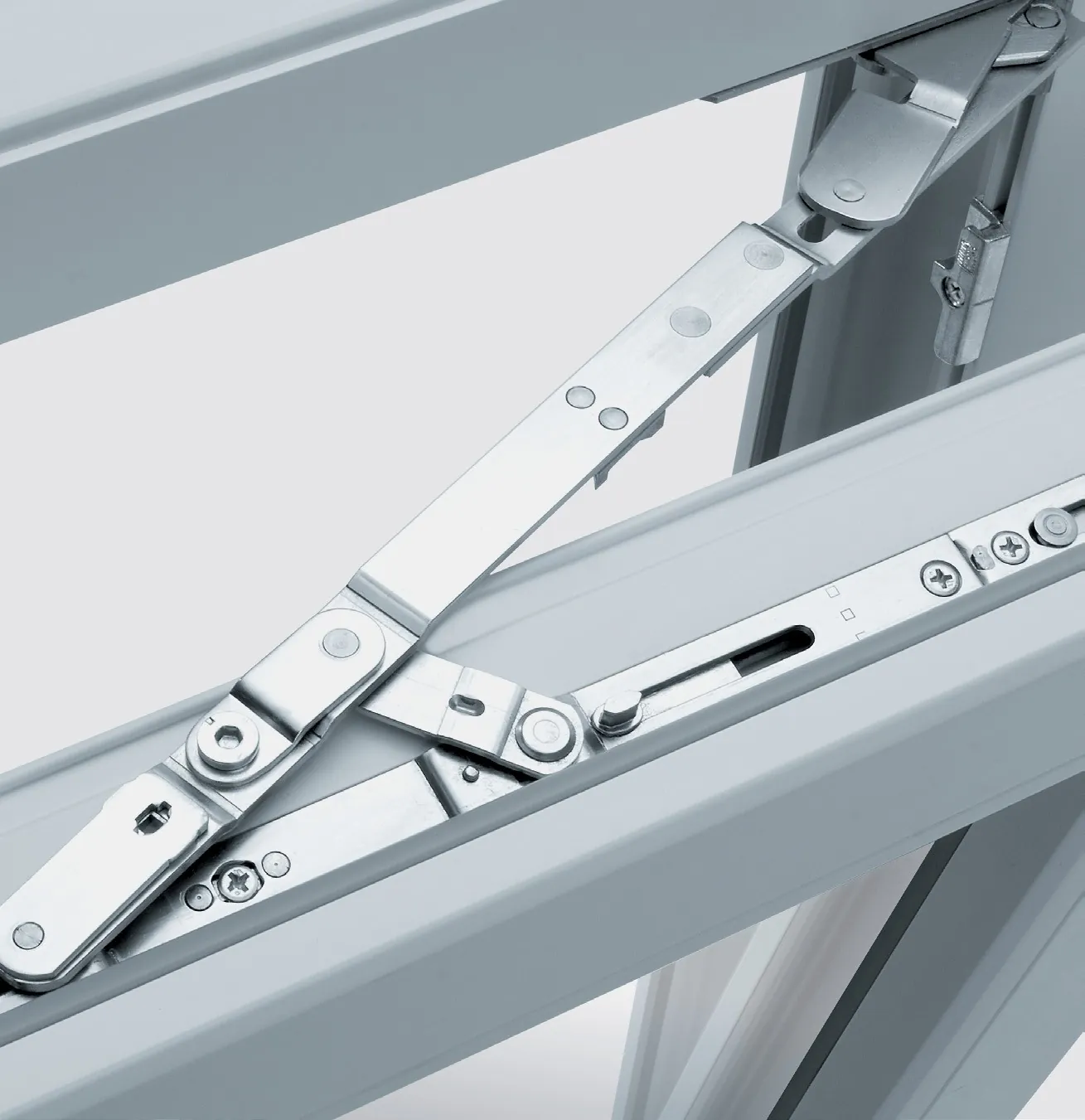 Close-up of the stay arms and hardware of a tilt-and-turn window