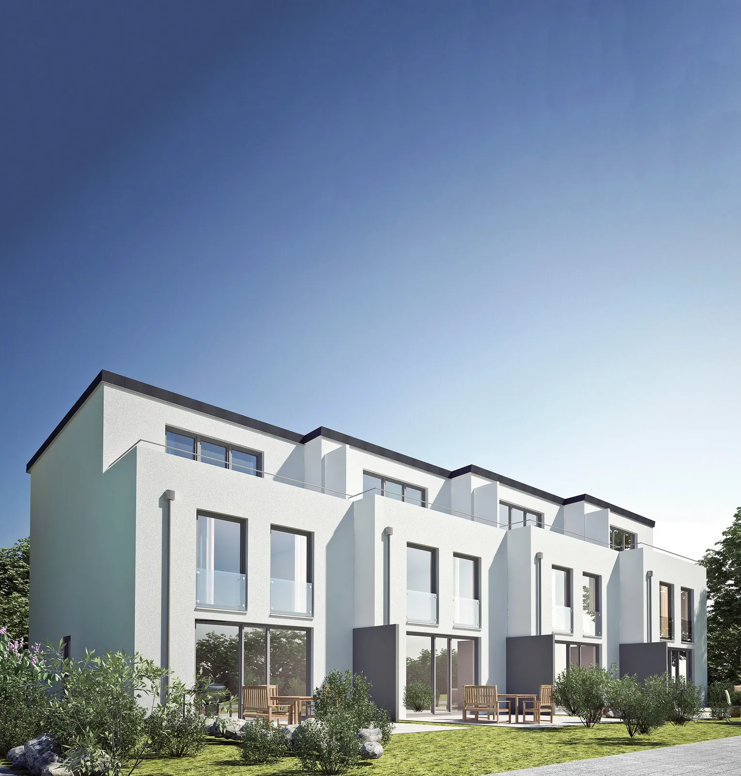 Row of white townhouses with many windows and sliding doors opening onto a garden